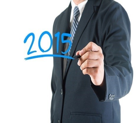 Businessman hand drawing 2015 happy new year on a whiteboard, is