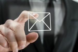 Businessman touching email icon on a virtual screen.