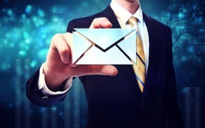 Business man with email envelopes on blue technology background