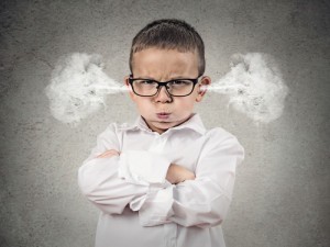 Closeup portrait Angry young Boy, Blowing Steam coming out of ears, about have Nervous atomic breakdown, isolated grey background. Negative human emotions, Facial Expression, feeling attitude reaction