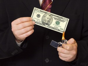 Hands and burnning money - business concept