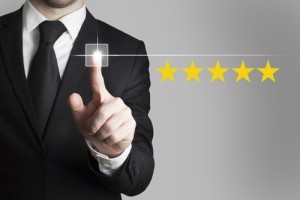 businessman in black suit pushing button five star rating